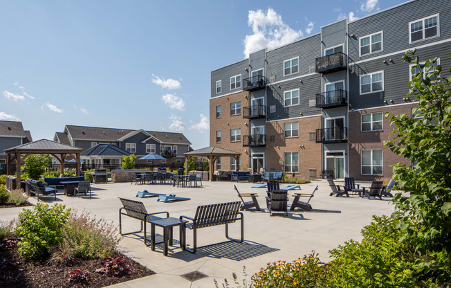 an outdoor lounge area at the enclave at woodbridge apartments in sugar land, tx