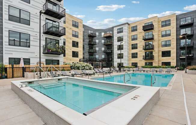 A swimming pool in front of apartment buildings.