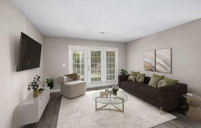 addison point interior staged model  living room with a couch and a tv