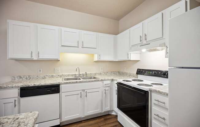 a kitchen with white cabinets and black appliances and white counter tops
