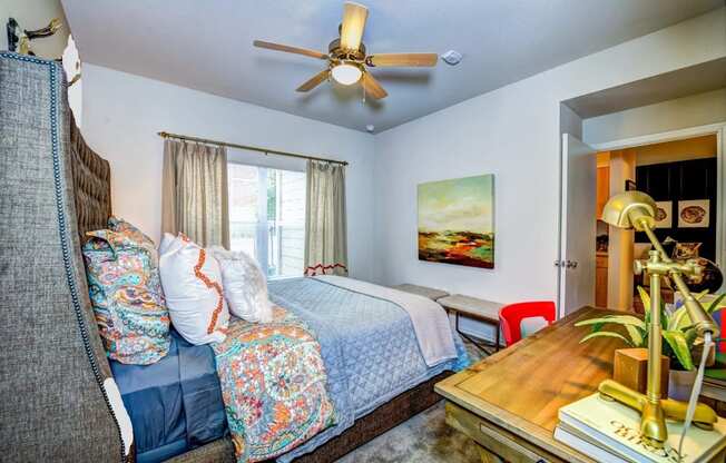 a bedroom with a bed and a ceiling fan at Villa Espada Apartments, San Antonio, TX, 78221