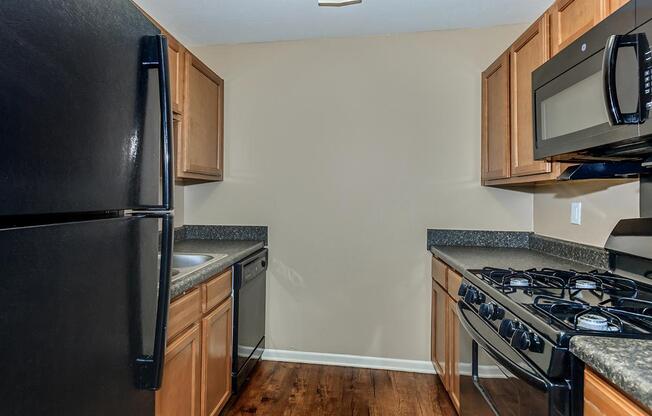 a modern kitchen with stainless steel appliances and wooden cabinets