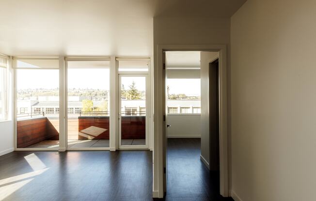 a living room with a view of a balcony and sliding glass doors