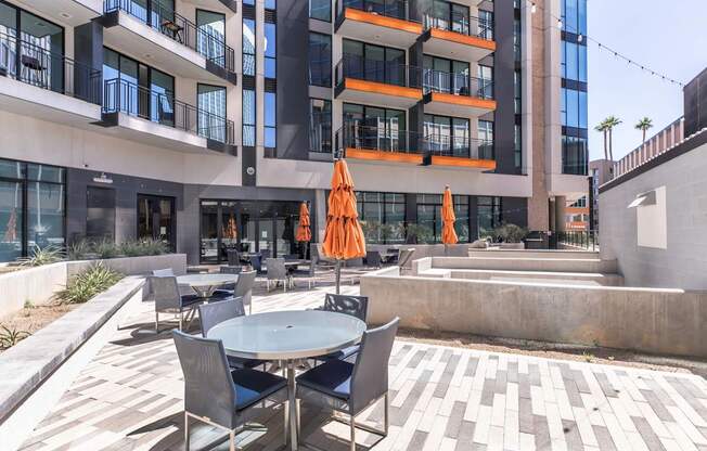 A modern building with a patio area in front.