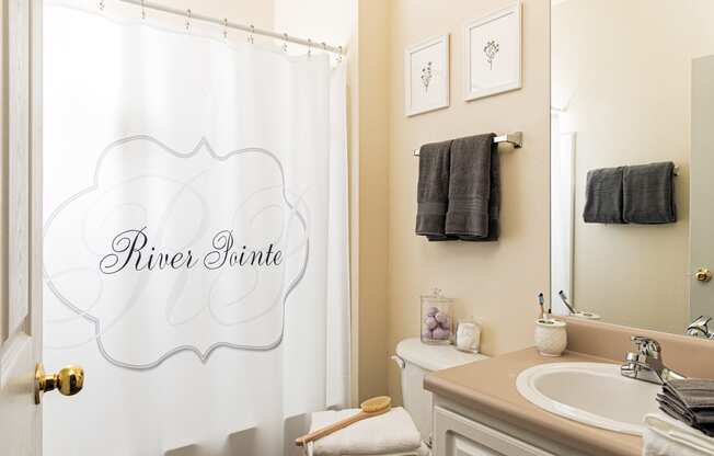a small bathroom with a white shower curtain