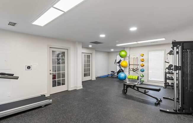 A spacious home gym with a bench, weights, and exercise equipment.