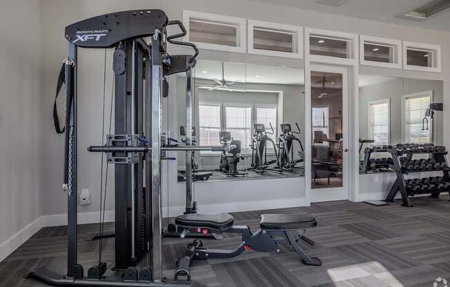 A gym with a variety of equipment including a leg press machine.at The Residences at Akita Lane, Canal Winchester Ohio