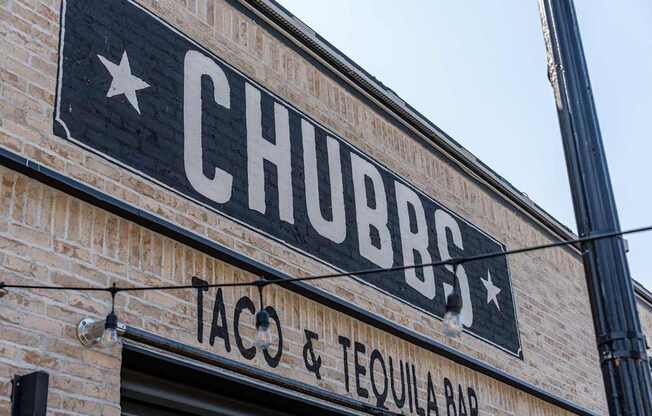 A brick building with a sign that says Chubbs Taco & Tequila Bar.