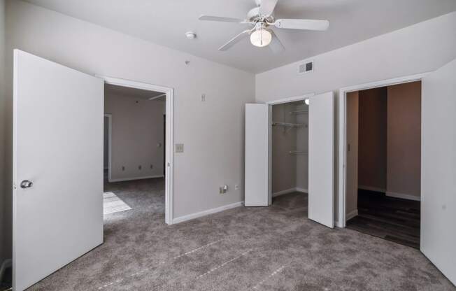 an empty room with three doors and a ceiling fan at St. Augustine Estate, Dallas, 75227