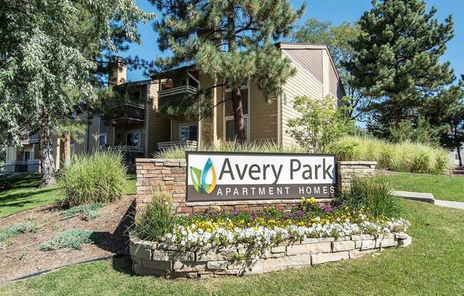 a sign that says avery park apartment homes in front of a house