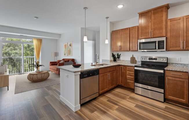 an open kitchen and living room with wooden floors and wooden cabinets