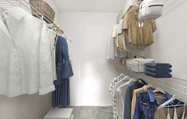 a small walk in closet with white walls and a carpeted floor
