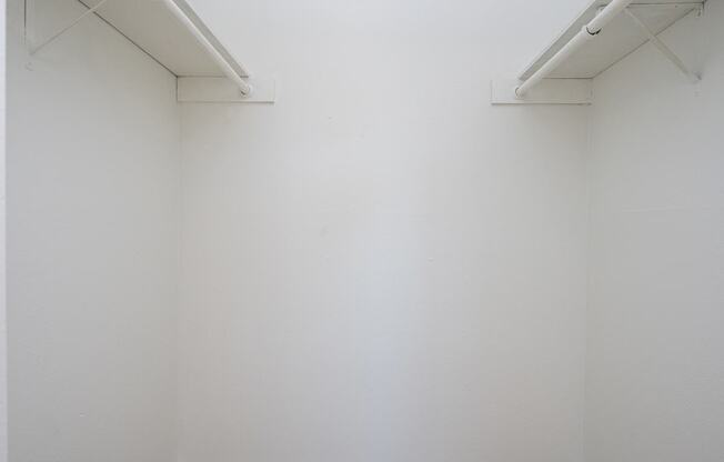 A white wall with two white bars on top.
