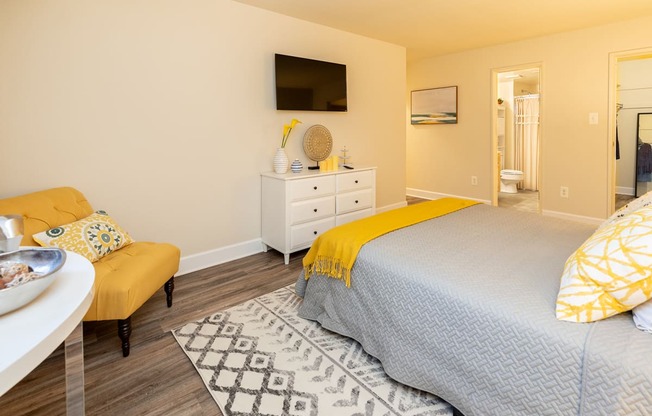 a bedroom with a carpet and dresser