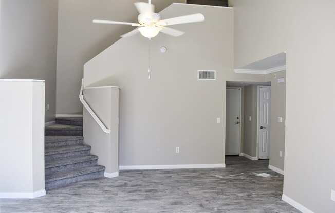 living room with stairs leading  to bedroom