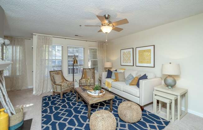 a living room with a ceiling fan and a white couch at Radbourne Lake Apartments, Charlotte, 28269 ? 