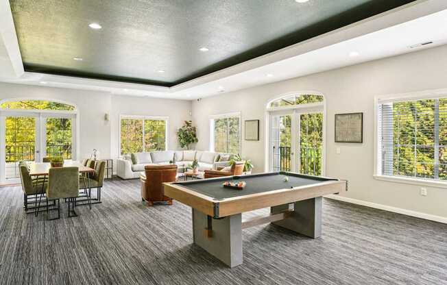 Clubhouse with a pool table and chairs