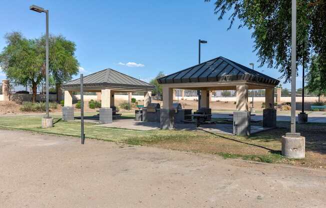 A gazebo-like structure sits in the middle of a park-like setting.