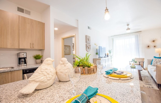 a kitchen and living room with a counter top and a table