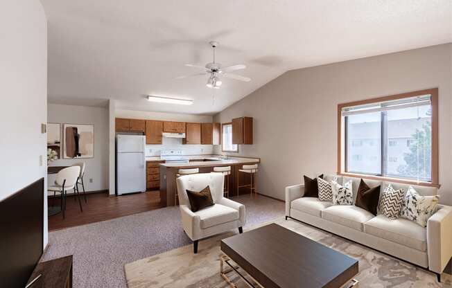 a living room and kitchen with a couch and a table. Fargo, ND Rosegate Apartments