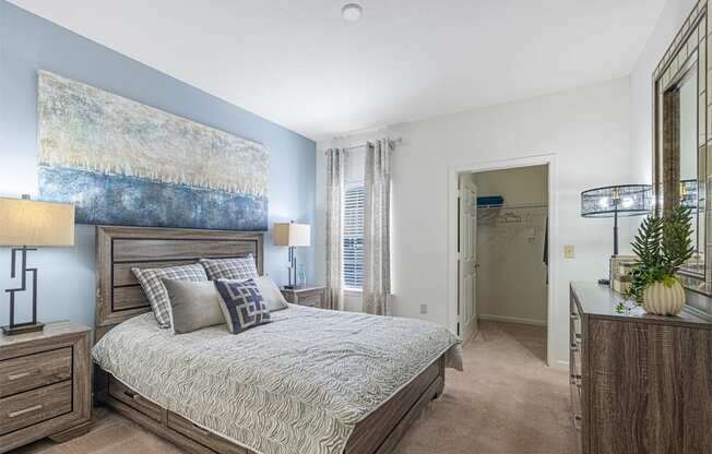 a bedroom with a bed and a painting on the wall
