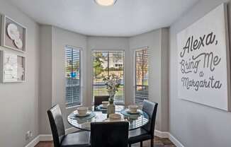 a dining room with a table and chairs and a window