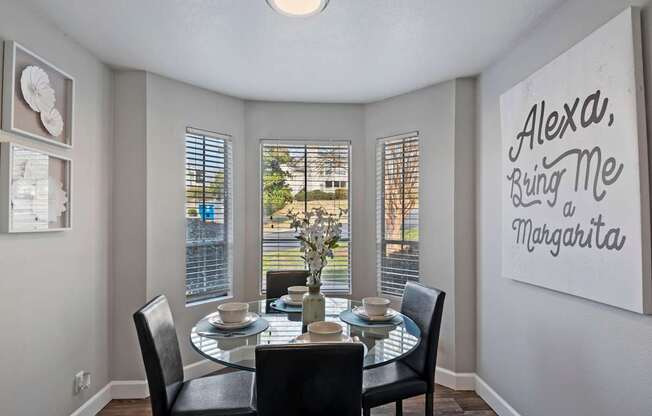 a dining room with a table and chairs and a window