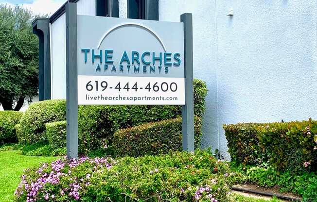 a sign for the arches in front of a building at The Arches Apartments, LLC, El Cajon California 