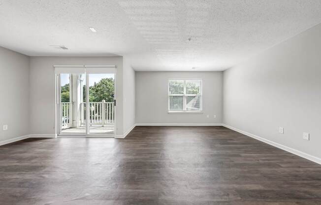 A large empty room with a sliding glass door.