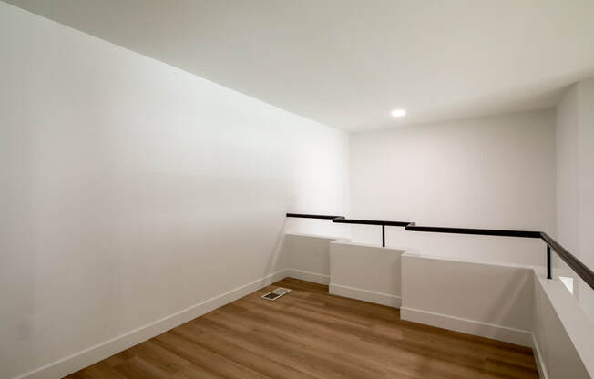 A room with wooden floors and white walls.