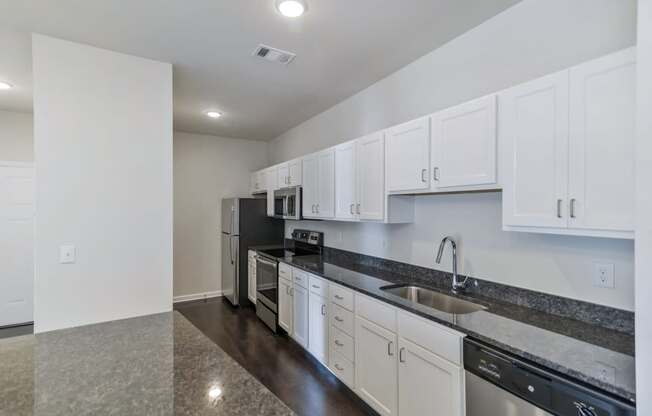Ashland Farms Galley Style Kitchen with Full Set of Stainless Steel Appliances and Modern White Cabinetry