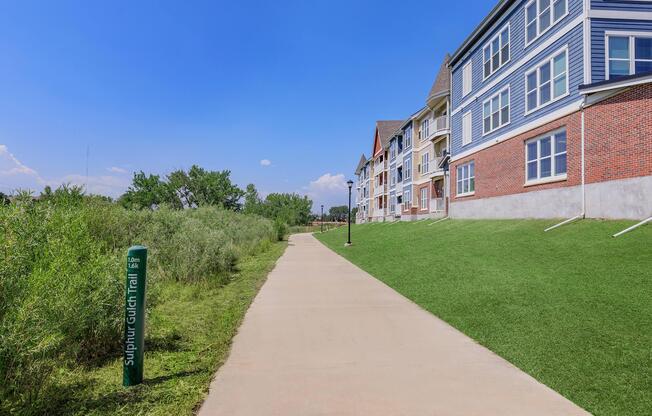 a large brick building with green grass