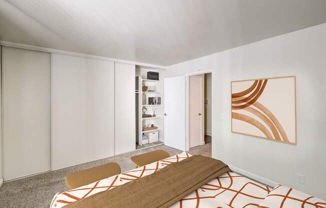 A room with a brown and white patterned rug and a wooden bench.