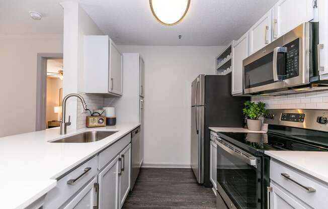 an empty kitchen with white cabinets and stainless steel appliances at Briarcliff Apartments, Atlanta, GA, 30329