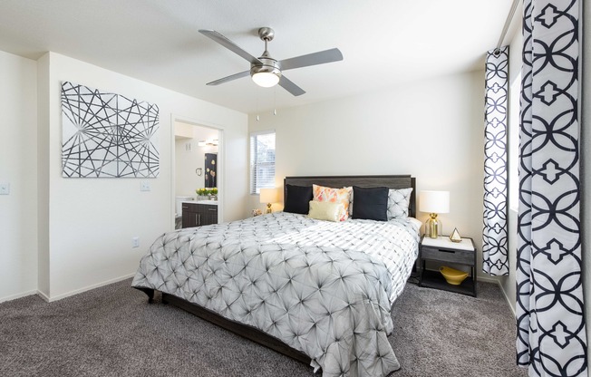 a bedroom with a bed and a ceiling fan