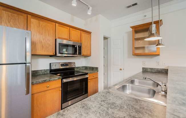 a kitchen with stainless steel appliances and granite counter tops