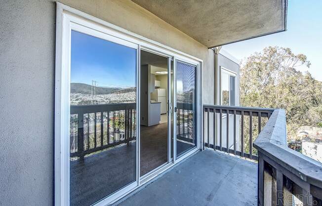 a balcony with a large window and a door that leads to the living room at Terrace View Apartments, Daly City California