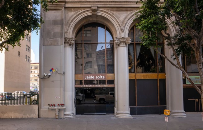the facade of a building with a glass door and an arched doorway