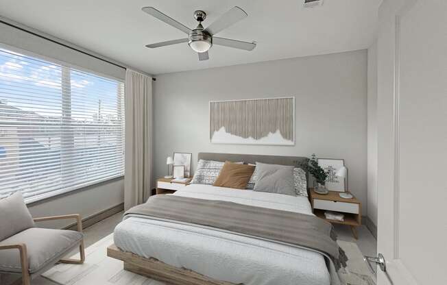 a bedroom with a large bed and a ceiling fan