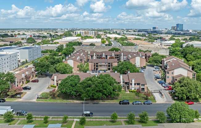 A view of a residential area with houses and cars.