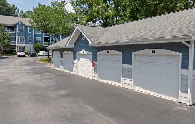 a row of garages in front of an apartment building