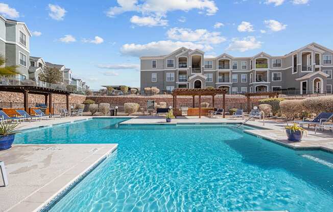a swimming pool with an apartment building in the background