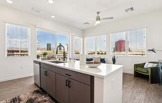 A kitchen with a large island and a view of the city.