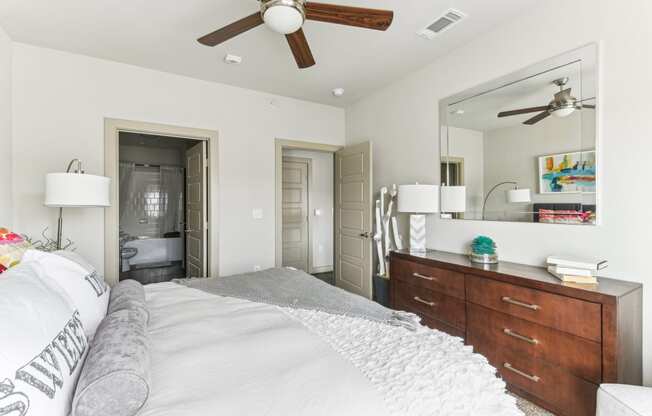 a bedroom with a large bed and a ceiling fan