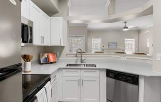 Kitchen with white shaker-style cabinets and stainless steel appliances