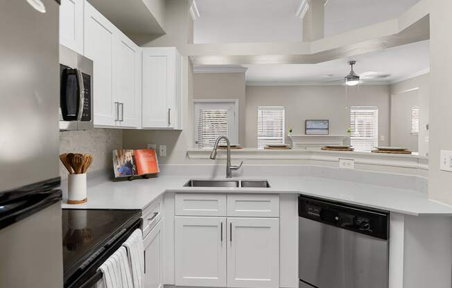 Kitchen with white shaker-style cabinets and stainless steel appliances