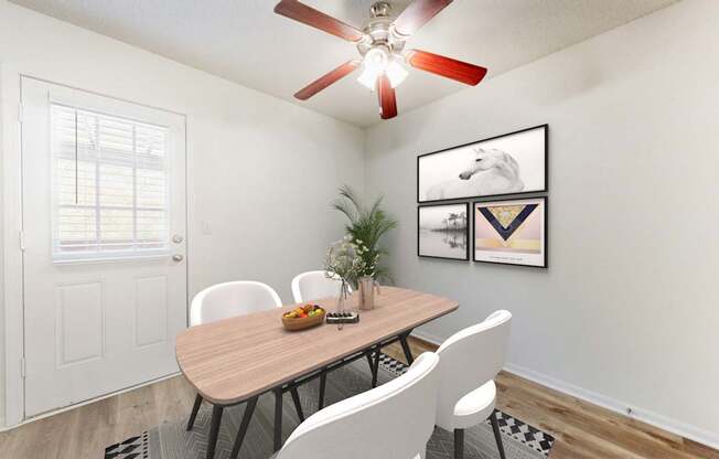 A dining room with a table, chairs, and a ceiling fan.