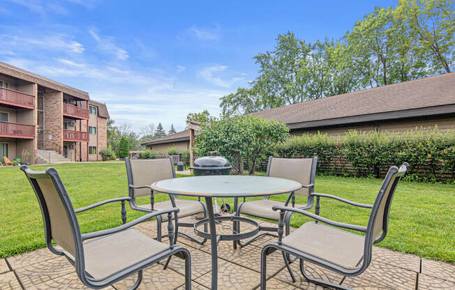A patio table with chairs is set up outside.