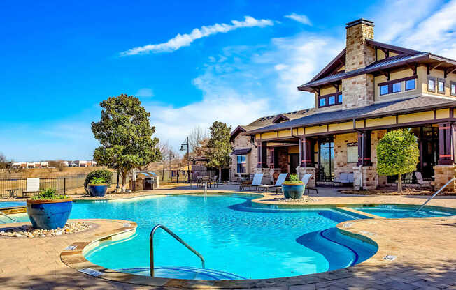 A large house with a pool in front.