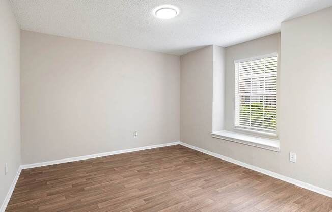 A room with wooden flooring and a window with blinds. at Mill House at East Cobb, Marietta, 30067